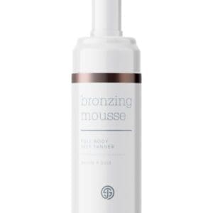 A white bottle of lotion sitting on top of a table.